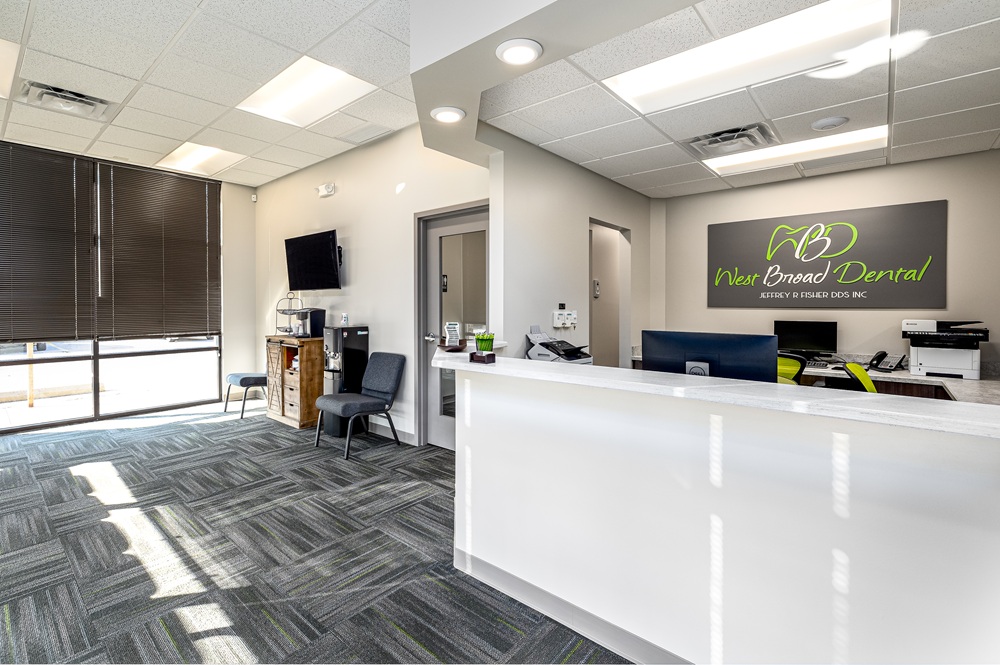 Bright and spacious waiting room area at West Broad Dental with comfortable patient seating and front desk.