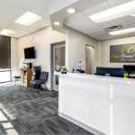 Bright and spacious waiting room area at West Broad Dental with comfortable patient seating and front desk.