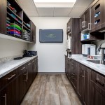 Sterilization and instrument preparation bay at West Broad Dental with custom cabinetry and sanitation equipment.